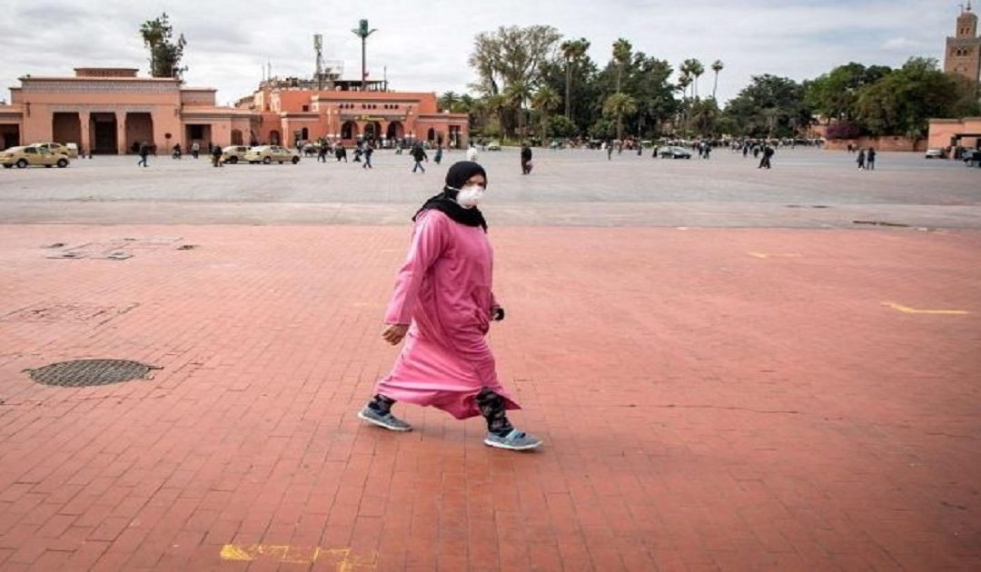 A woman walking near the famous Jamaa El Fna square in Marrakesh, Morocco.